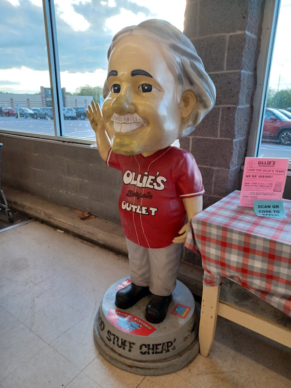 A life-sized bobble head statue of the Ollie's Bargain Outlet mascot.
